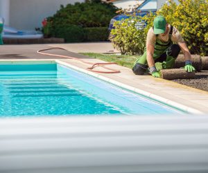 New Grass Turfs Installation Next to Residential Swimming Pool in the Backyard Garden. Caucasian Professional Landscaper at Work.; Shutterstock ID 1794449437; other: -; client: -; Job: -; PO: -